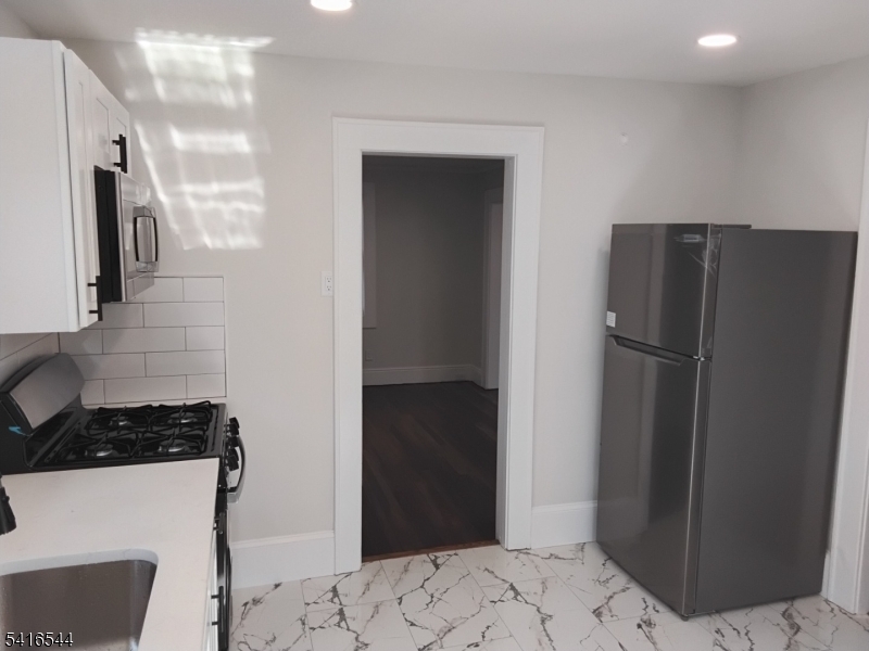 152 Mountain Avenue Springfield, NJ 07081 - Photo 4 of 7 a kitchen with a refrigerator and a stove top oven