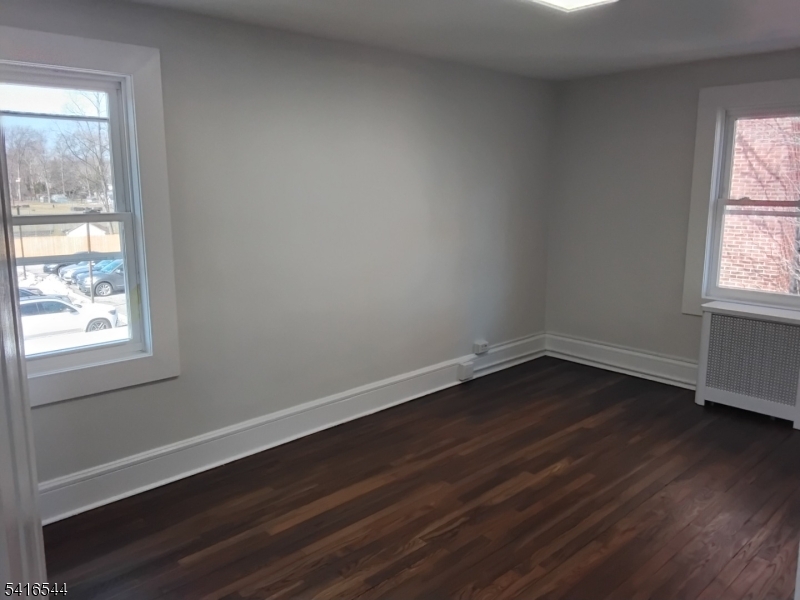 152 Mountain Avenue Springfield, NJ 07081 - Photo 6 of 7 an empty room with wooden floor and windows