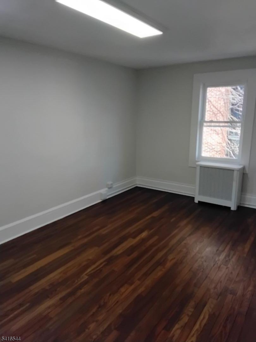 152 Mountain Avenue Springfield, NJ 07081 - Photo 7 of 7 an empty room with wooden floor and windows