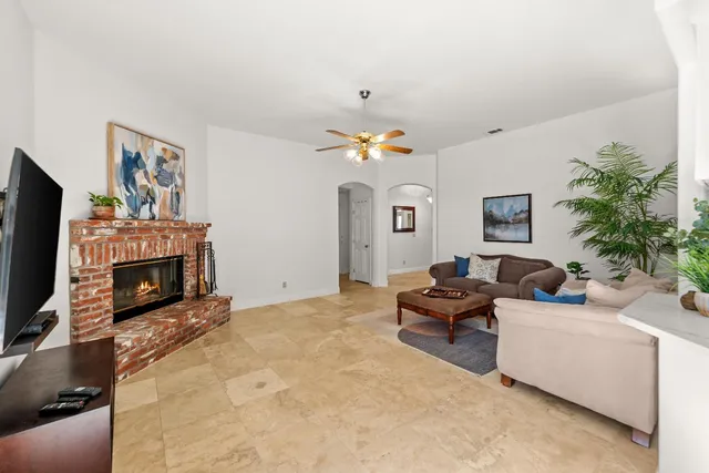 a living room with furniture a fireplace and a flat screen tv