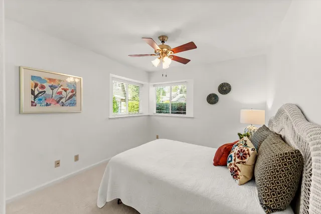 a bedroom with a bed and a painting on the wall