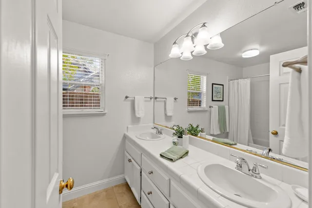 a bathroom with a sink a vanity and a mirror