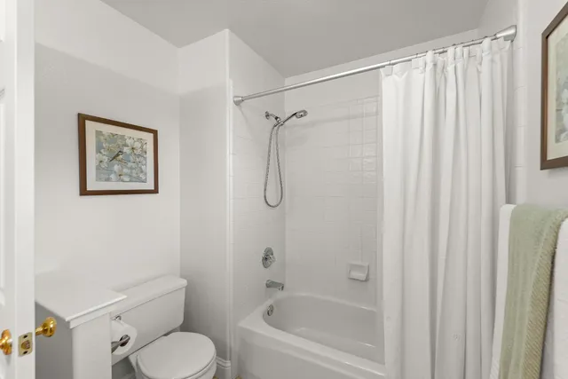 a bathroom with a toilet and shower