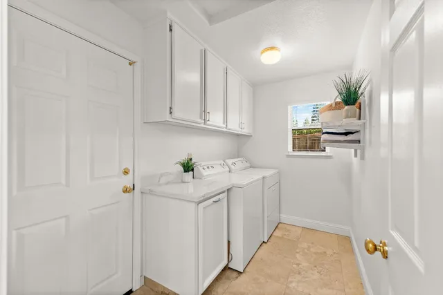 a room with white cabinets and wooden floor