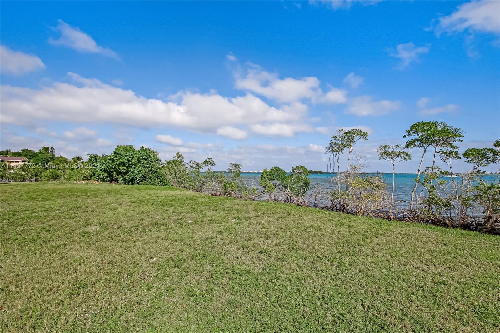 148-150 South Sewalls Point Road Stuart, FL 34996 - Photo 14 of 59 a view of a garden with a building in the background