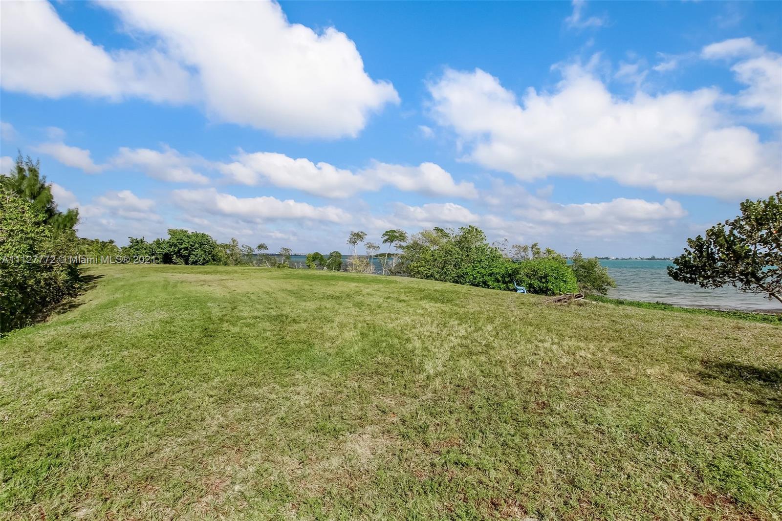 148-150 South Sewalls Point Road Stuart, FL 34996 - Photo 35 of 59 a view of a lake with a big yard