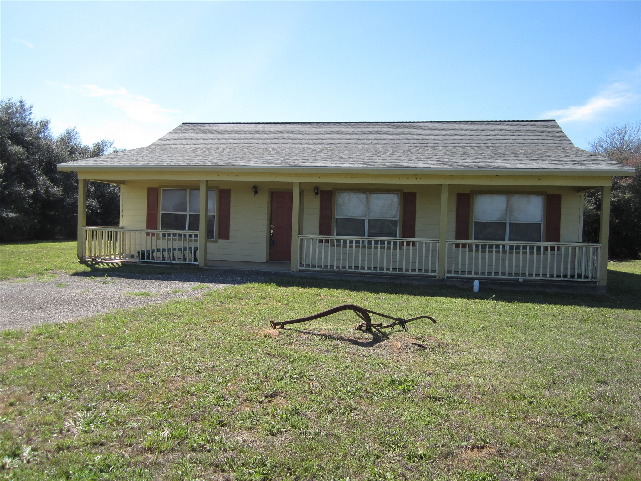  This adorable ranch-style home features a welcoming front porch, a gable roof, and shutters on the windows. Situated on a spacious grassy 1.3+/- acre lot, it offers ample outdoor space for activities and landscaping.