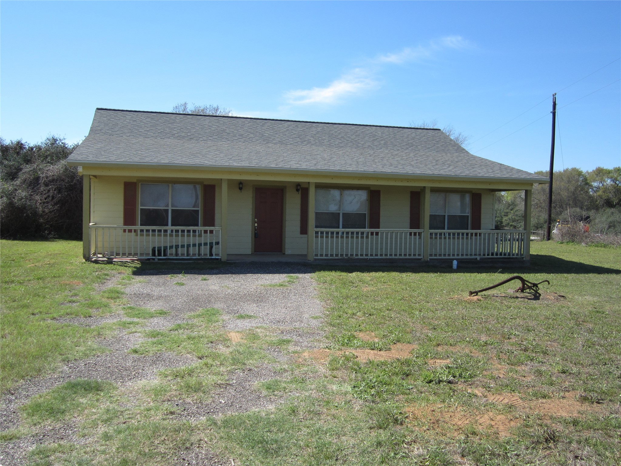 20697 Pierceall Road Hempstead, TX 77445 - Photo 2 of 35 Offers a welcoming front porch and a covered back porch. It features a spacious yard and a gravel driveway, set in a serene, natural setting. Ideal for those seeking a peaceful retreat.