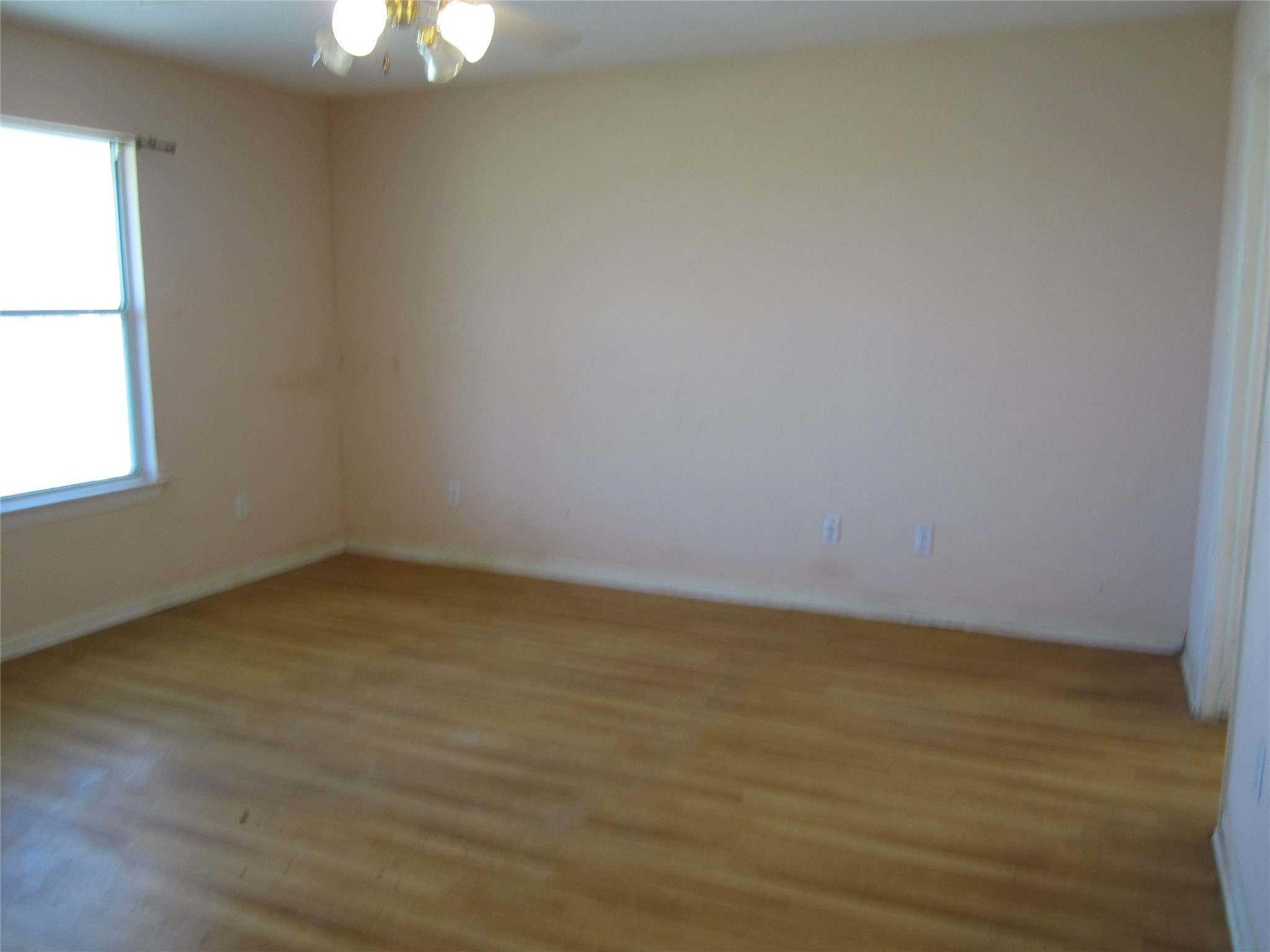 20697 Pierceall Road Hempstead, TX 77445 - Photo 22 of 35 Primary bedroom offers a large window providing natural light, and a ceiling fan.