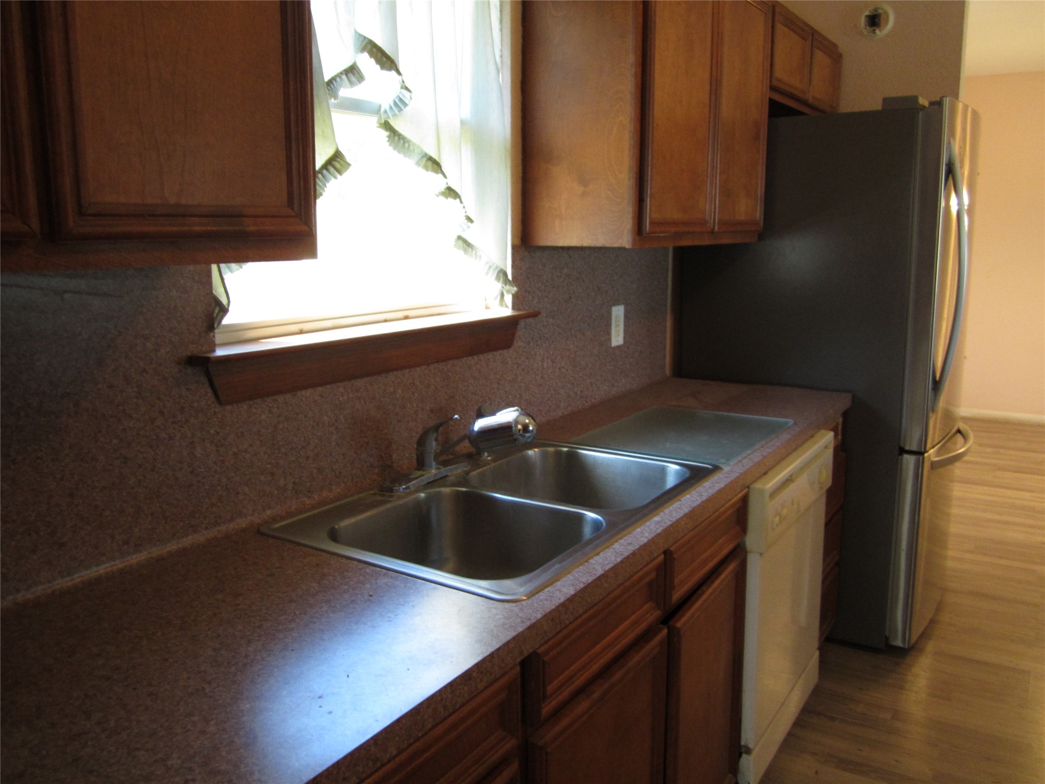 20697 Pierceall Road Hempstead, TX 77445 - Photo 7 of 35 This kitchen natural light streams through a window, enhancing the warm, inviting atmosphere.