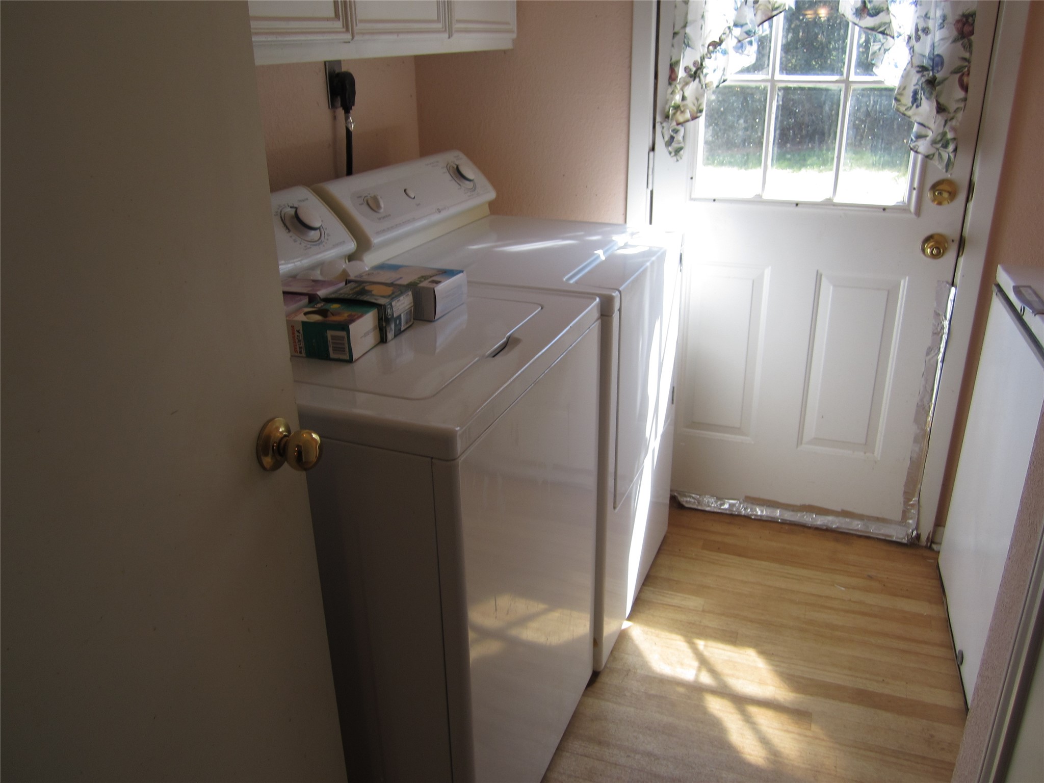 20697 Pierceall Road Hempstead, TX 77445 - Photo 10 of 35 Compact laundry room with a washer and dryer, natural light from a side door with a window. Washer and dryer will convey with the sale of the home.