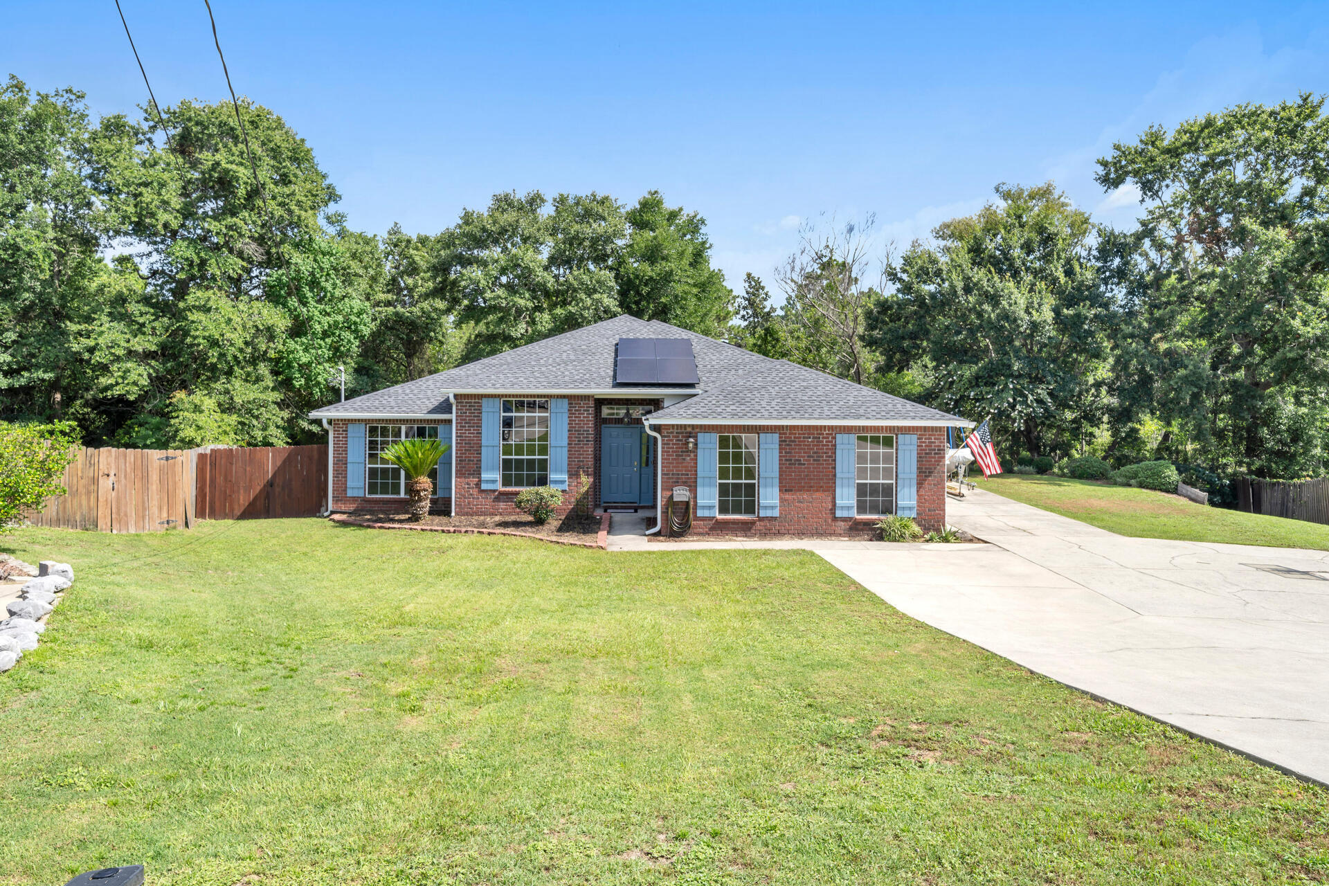 a front view of a house with yard porch and furniture