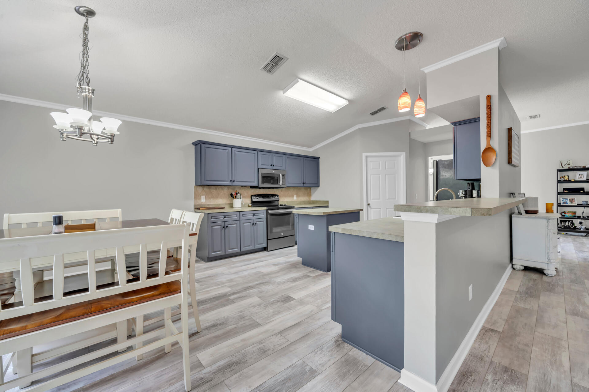 318 Peggy Drive Crestview, FL 32536 - Photo 19 of 47 a kitchen with cabinets a counter and stainless steel appliances