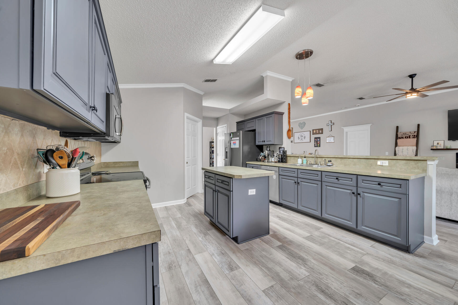318 Peggy Drive Crestview, FL 32536 - Photo 21 of 47 a kitchen with sink a stove and cabinets