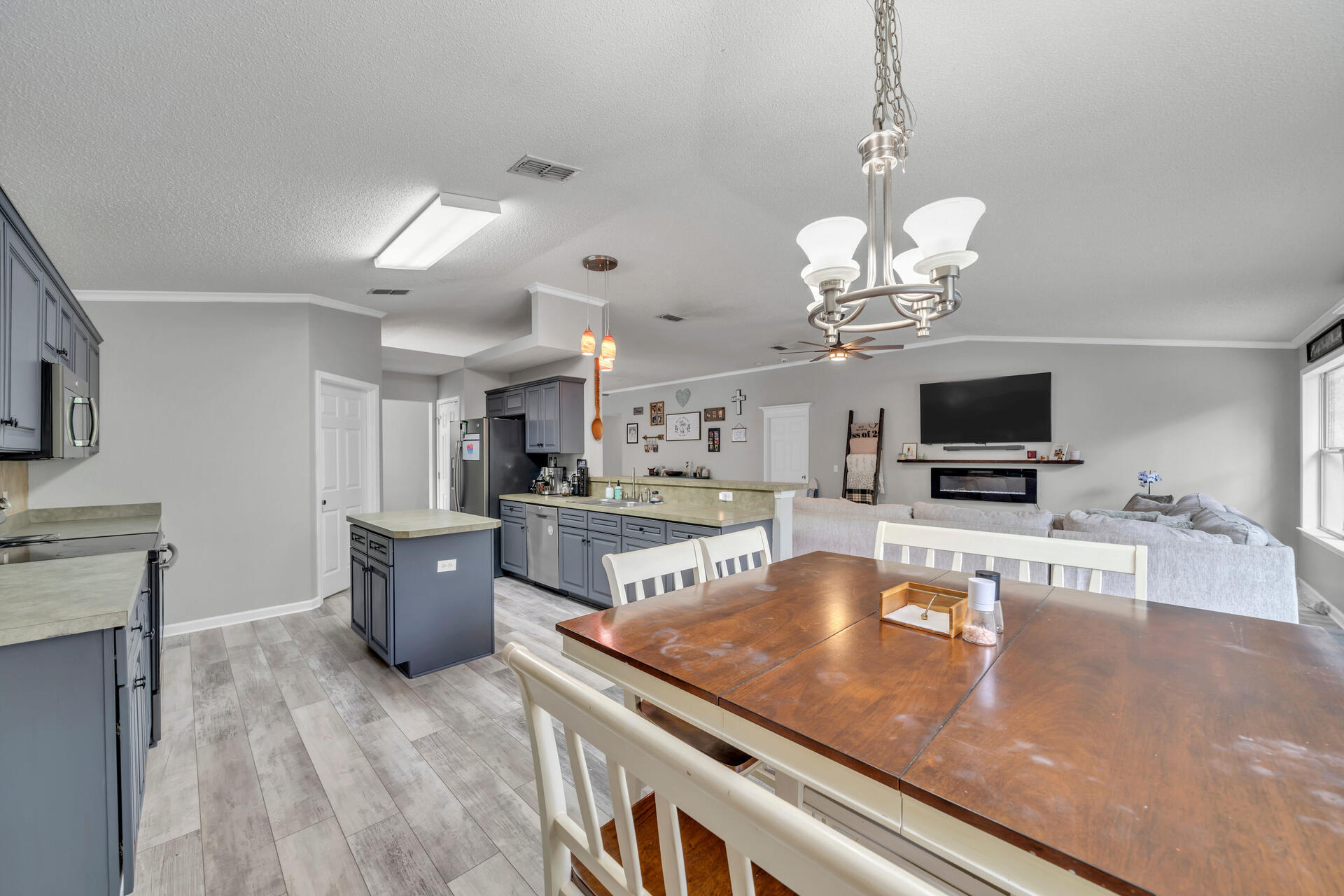 318 Peggy Drive Crestview, FL 32536 - Photo 23 of 47 a view of a dining room kitchen with furniture a chandelier and wooden floor