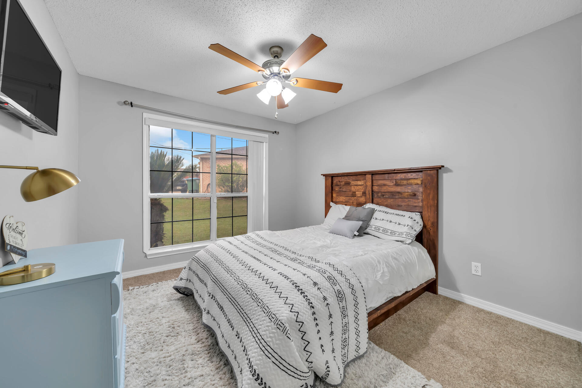 318 Peggy Drive Crestview, FL 32536 - Photo 30 of 47 a bedroom with a large bed and a flat tv screen on dresser