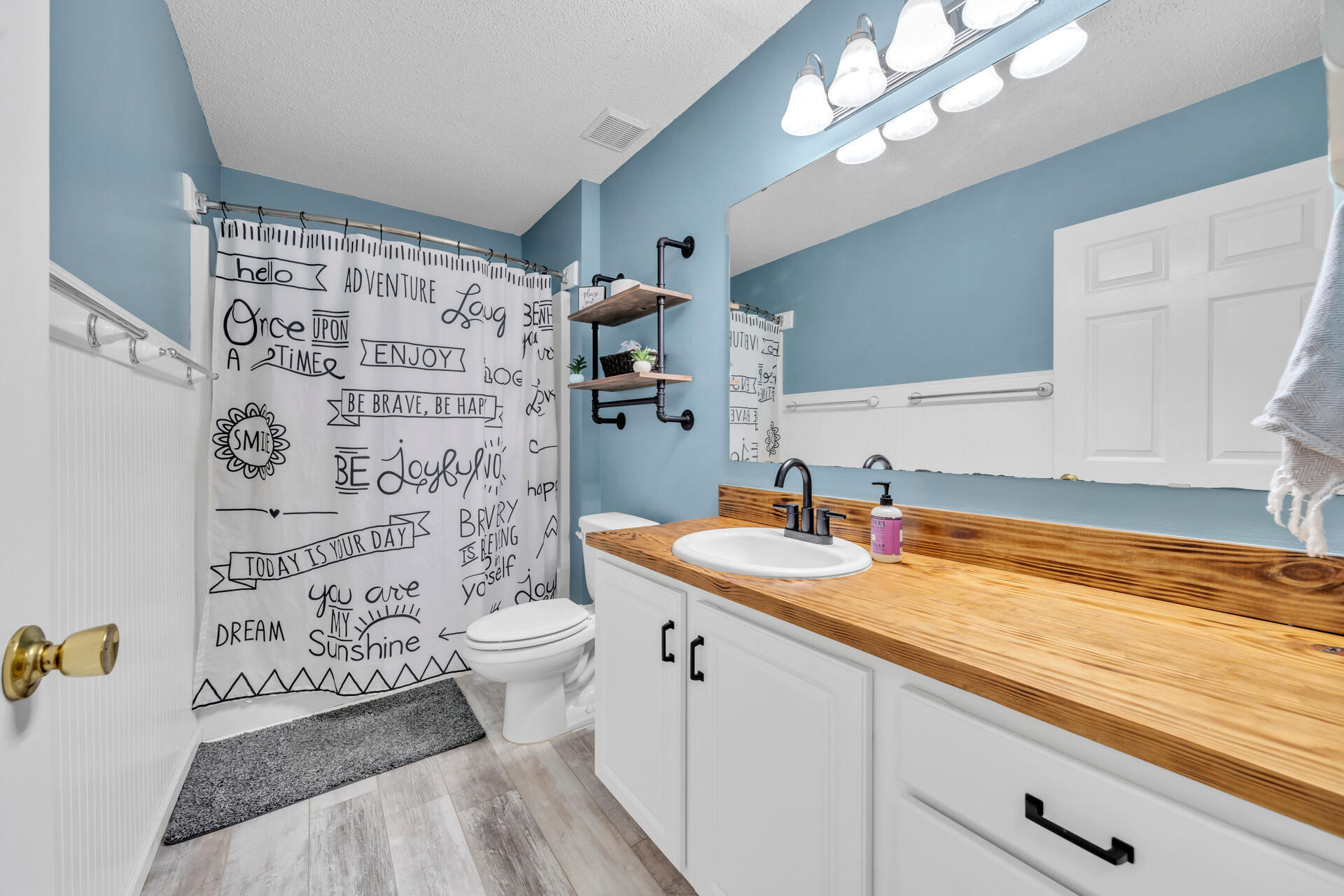 318 Peggy Drive Crestview, FL 32536 - Photo 32 of 47 a bathroom with a sink a toilet and shower curtain