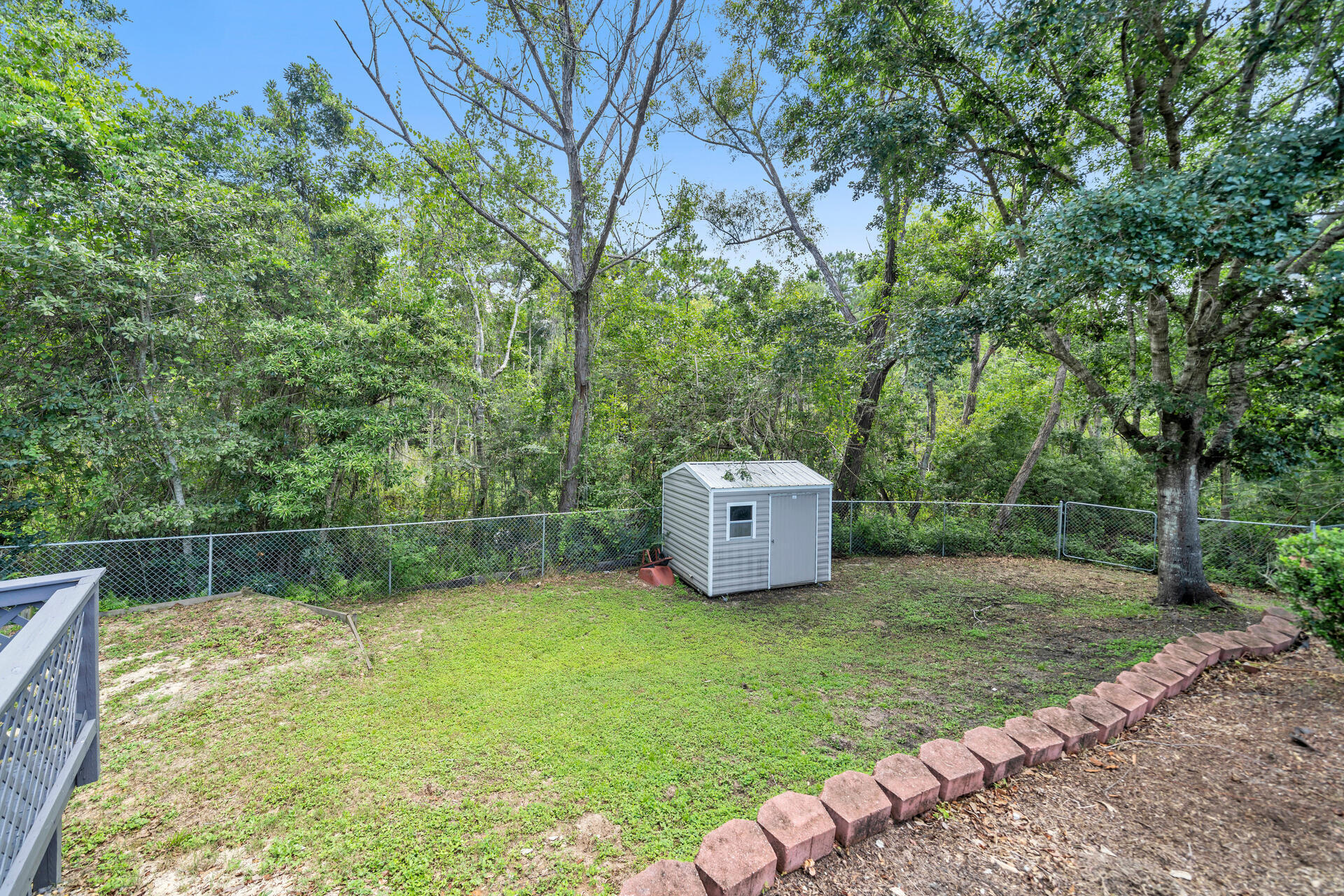 318 Peggy Drive Crestview, FL 32536 - Photo 43 of 47 a view of a backyard with a small cabin