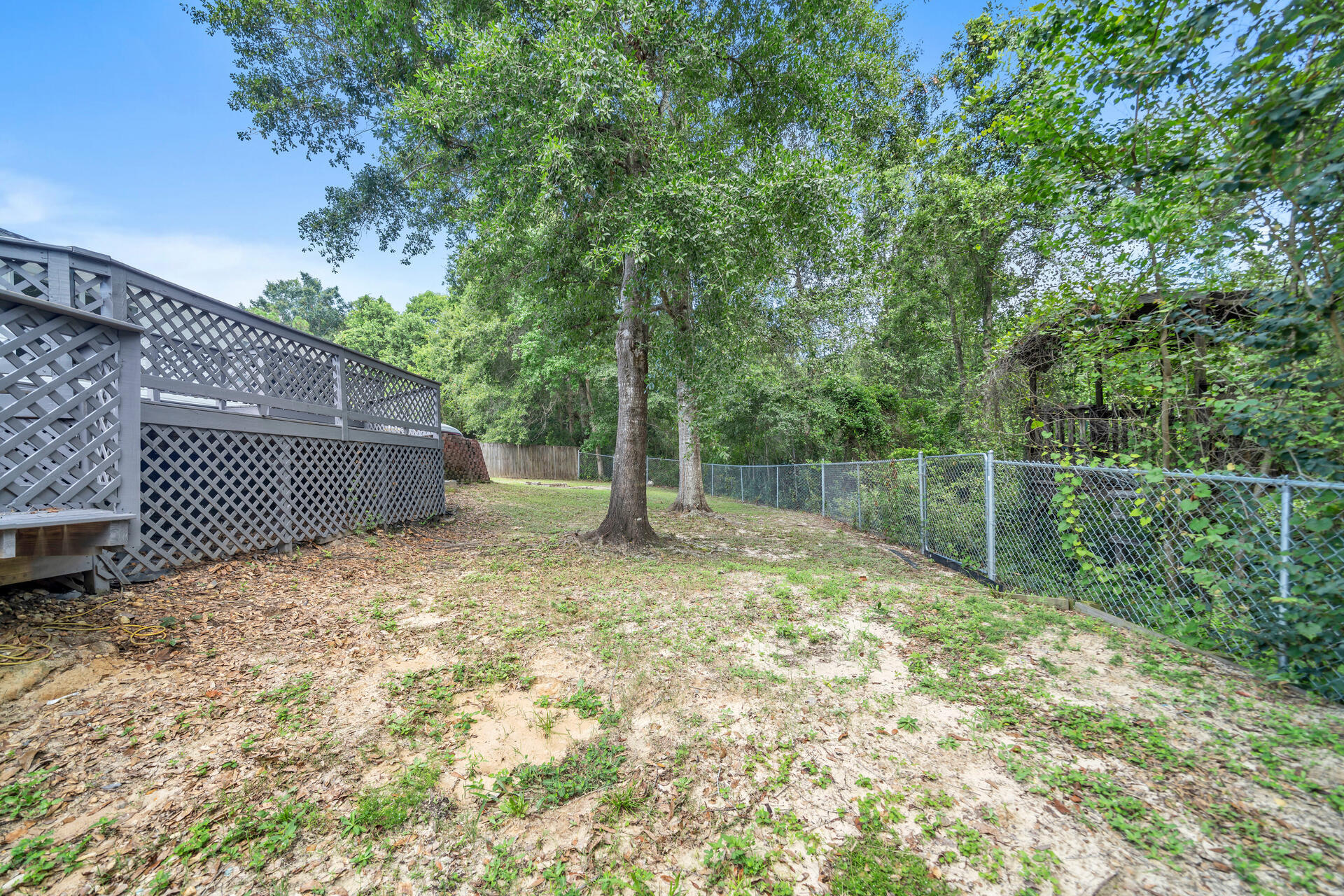 318 Peggy Drive Crestview, FL 32536 - Photo 45 of 47 a backyard of a house with a tree