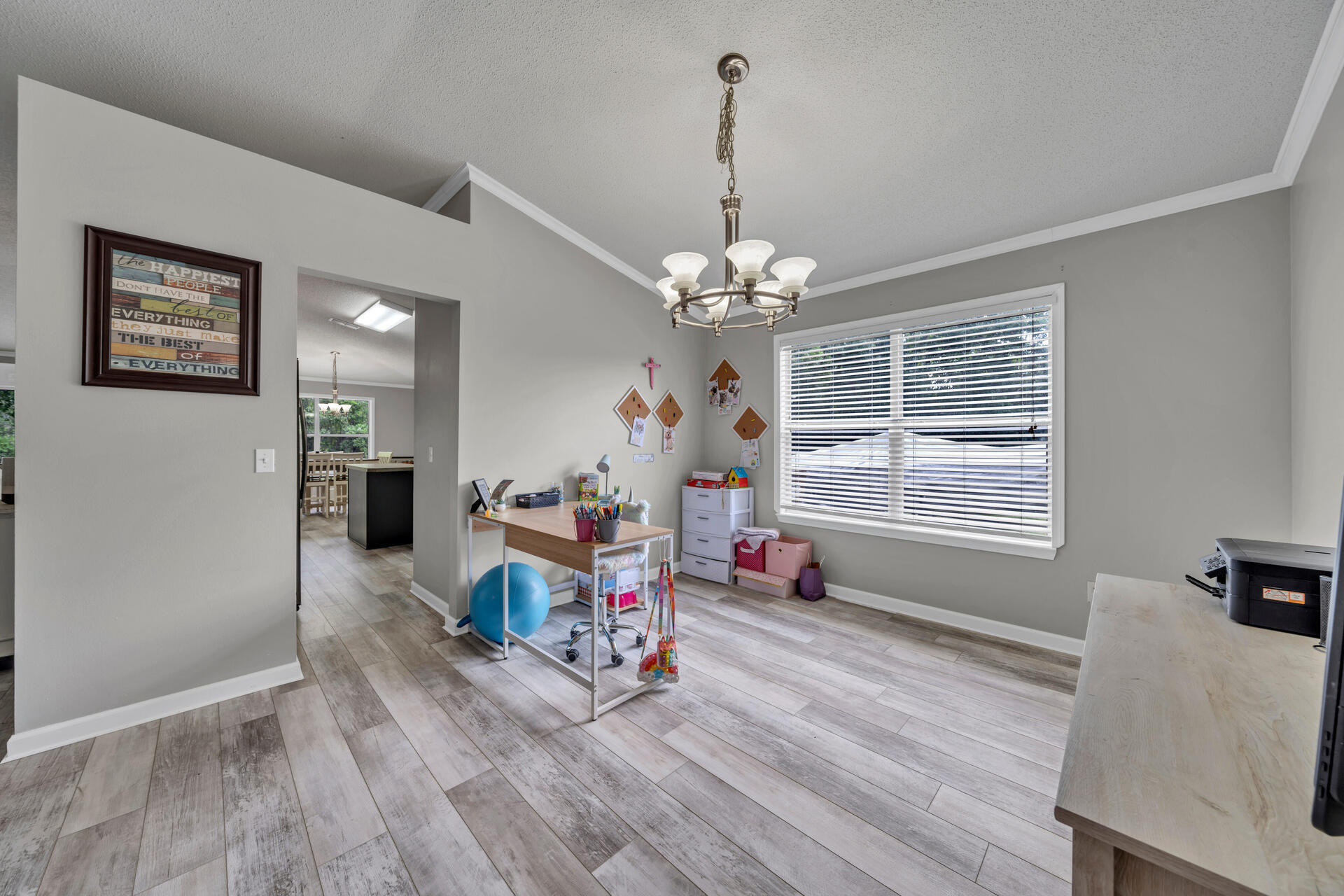318 Peggy Drive Crestview, FL 32536 - Photo 9 of 47 a living room with furniture and a chandelier