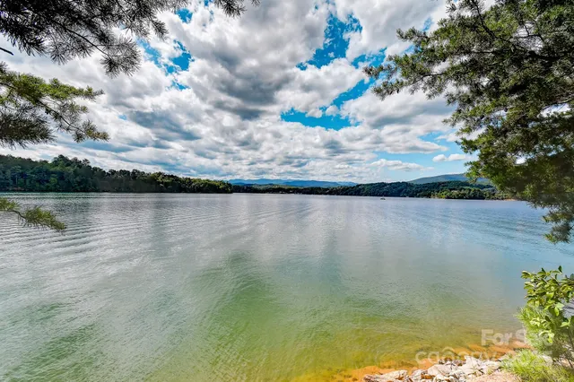 a view of a house with a backyard and sitting area
