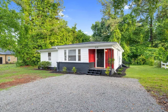 a view of house with outdoor space and yard