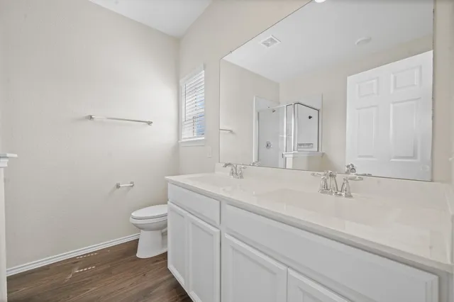 a bathroom with a sink a toilet and a mirror
