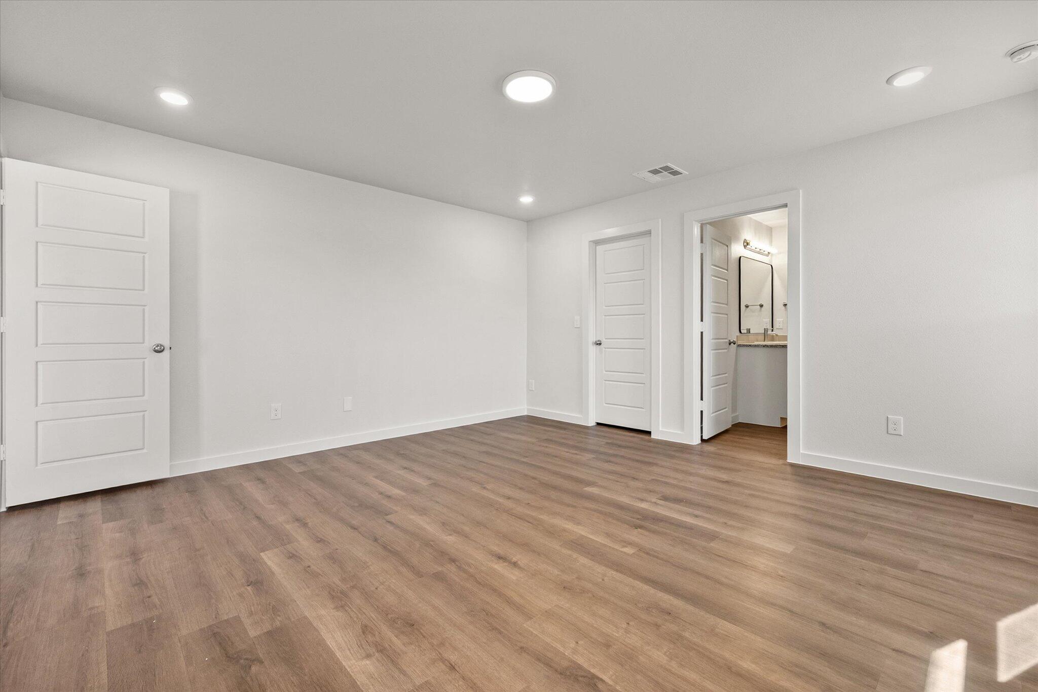 1317 North Chicago Avenue Lubbock, TX 79416 - Photo 13 of 20 a view of an empty room with wooden floor