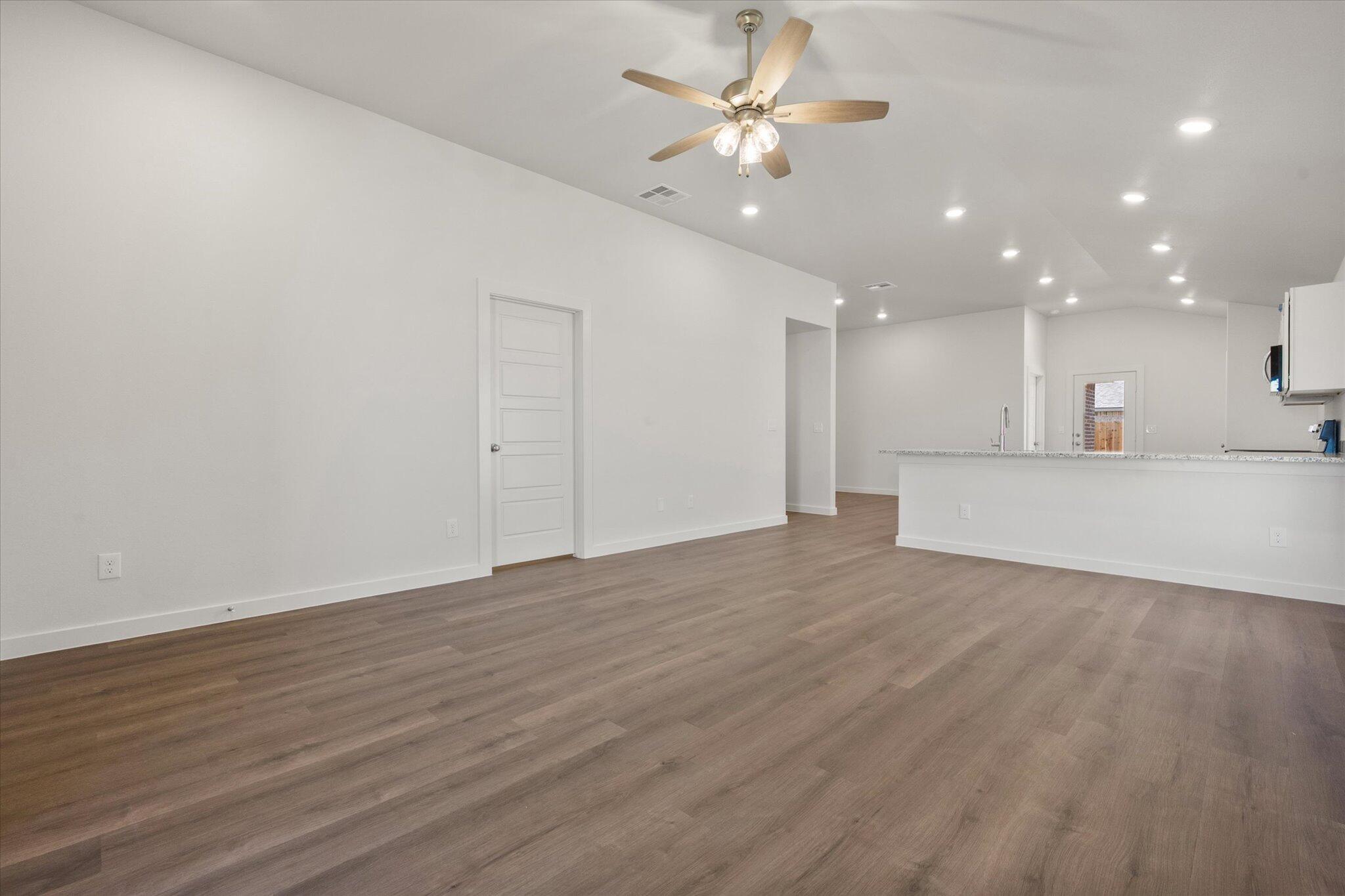 1317 North Chicago Avenue Lubbock, TX 79416 - Photo 4 of 20 a view of an empty room with a kitchen