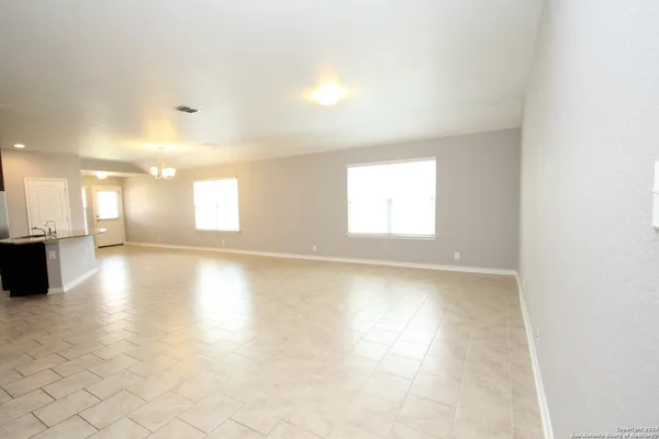 an empty room with large windows