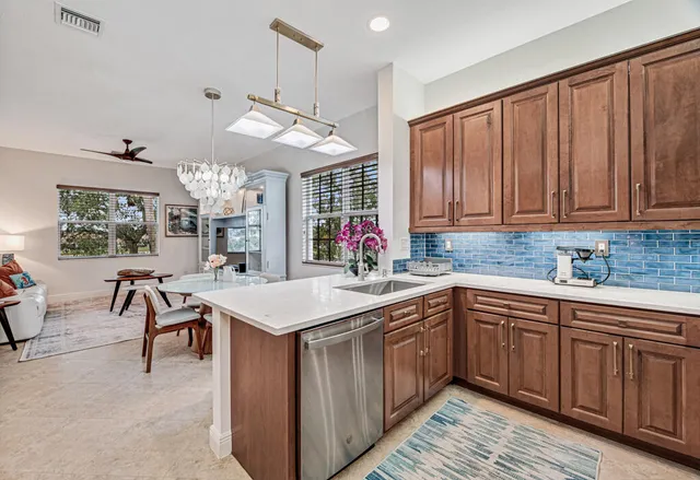 a kitchen with a sink cabinets and wooden floor