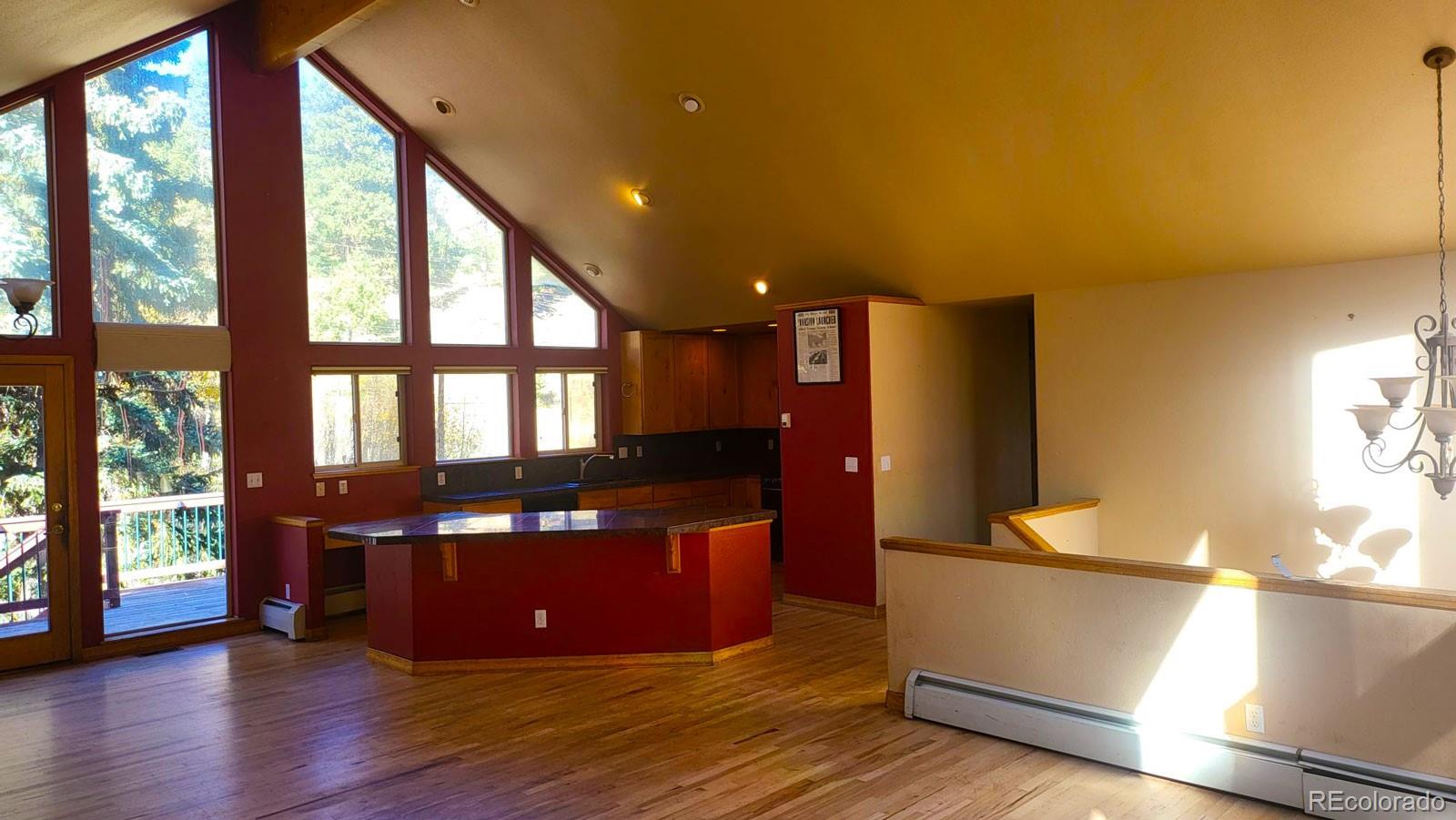 294 Red Tail Trail Evergreen, CO 80439 - Photo 11 of 35 a view of kitchen with granite countertop counter top space and wooden floor