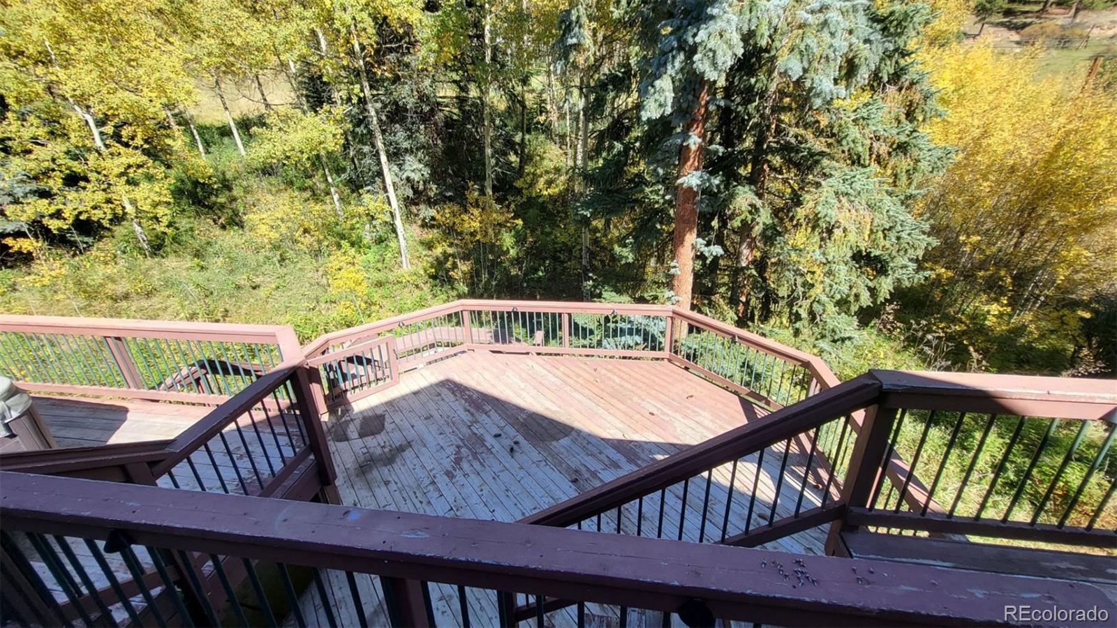 294 Red Tail Trail Evergreen, CO 80439 - Photo 16 of 35 a view of a balcony with wooden fence