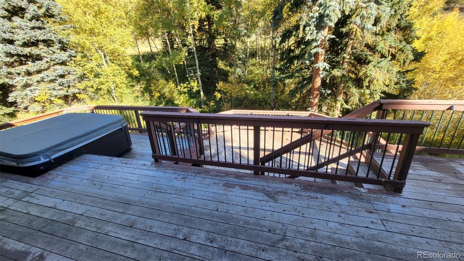 294 Red Tail Trail Evergreen, CO 80439 - Photo 18 of 35 a view of deck with two chairs and wooden floor