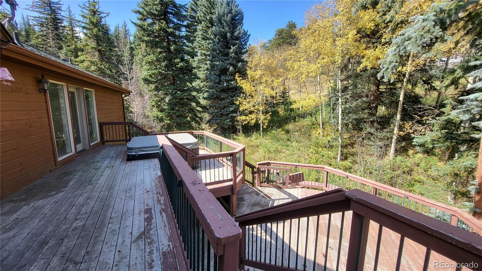 294 Red Tail Trail Evergreen, CO 80439 - Photo 19 of 35 a view of a balcony with wooden floor and fence