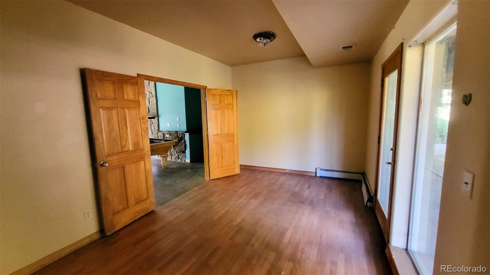 294 Red Tail Trail Evergreen, CO 80439 - Photo 27 of 35 an empty room with wooden floor and a window
