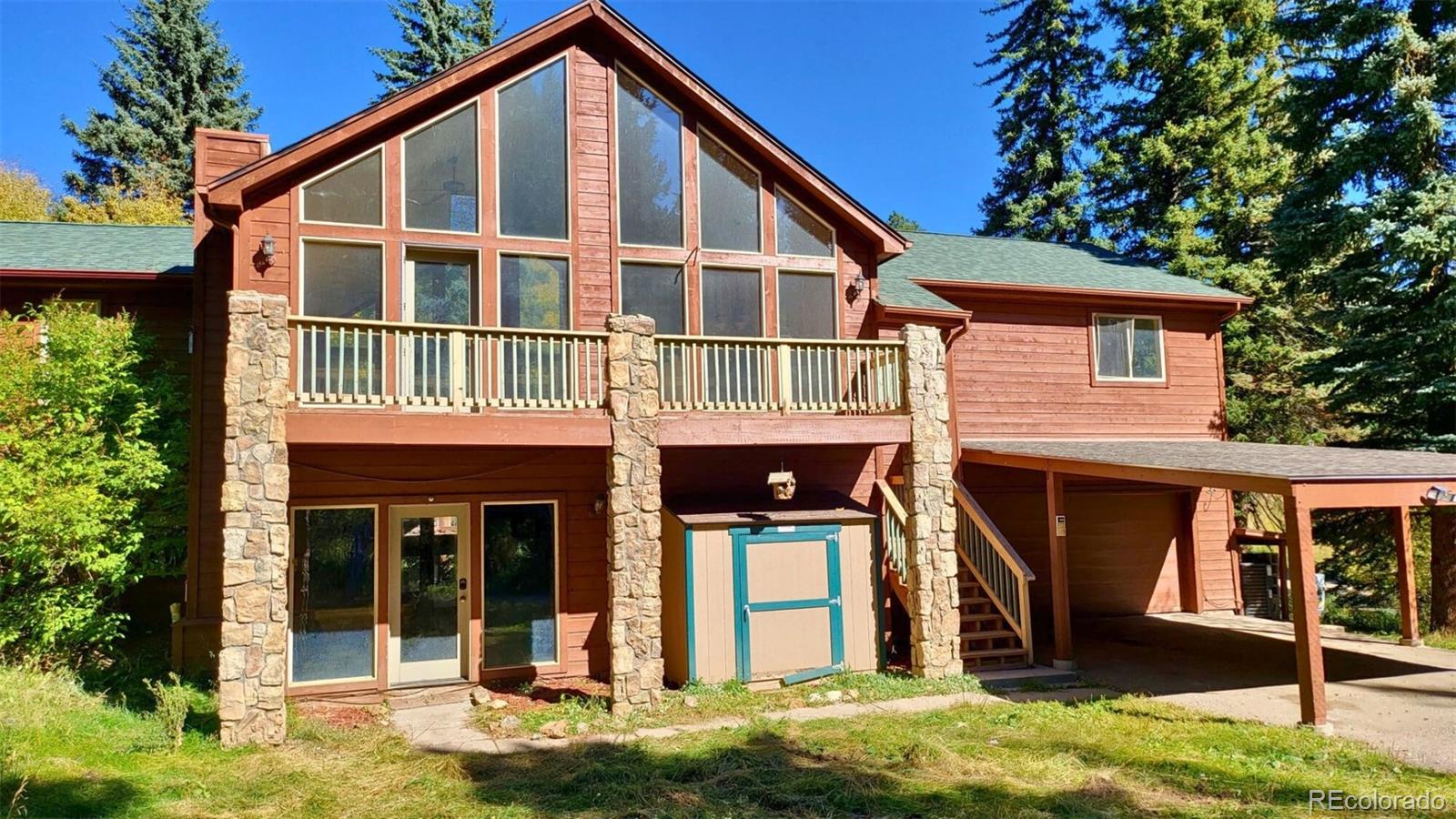 294 Red Tail Trail Evergreen, CO 80439 - Photo 34 of 35 a front view of a house with a yard