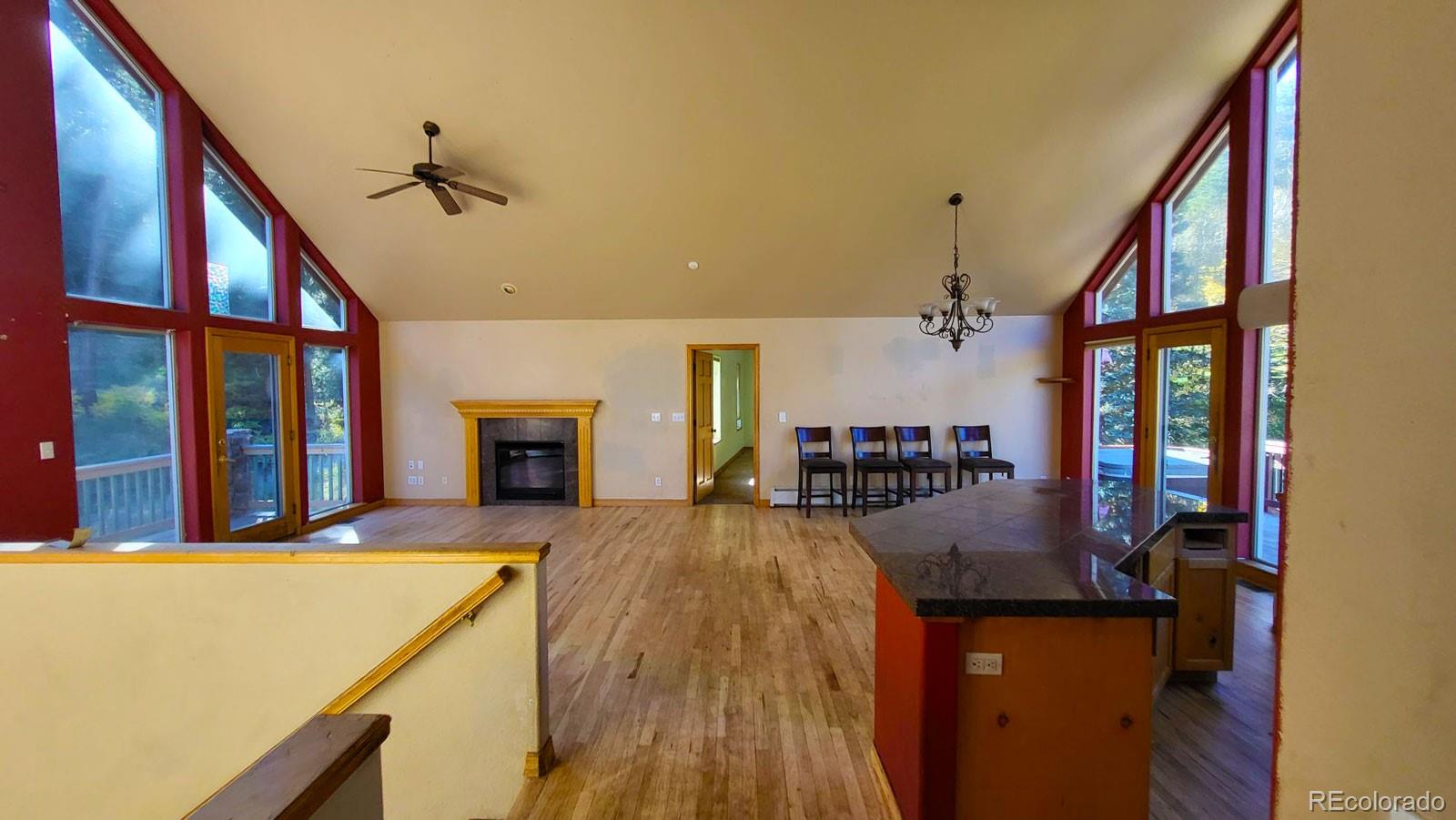 294 Red Tail Trail Evergreen, CO 80439 - Photo 5 of 35 a very nice looking room with a large window and a fireplace