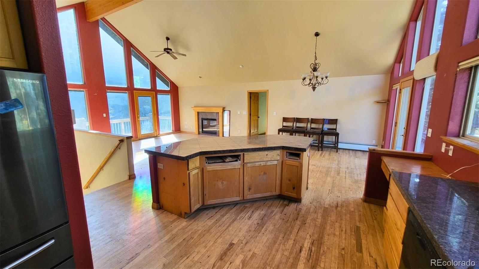 294 Red Tail Trail Evergreen, CO 80439 - Photo 7 of 35 a kitchen with stainless steel appliances granite countertop a stove and wooden floor