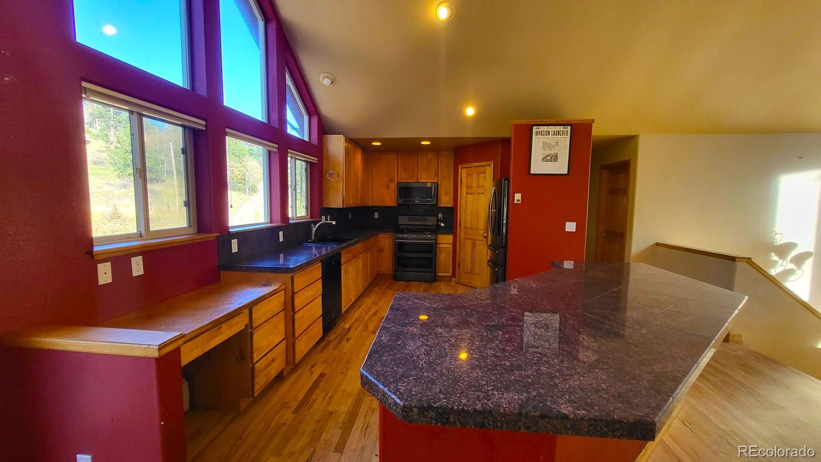 294 Red Tail Trail Evergreen, CO 80439 - Photo 9 of 35 a kitchen with counter top space a sink and appliances