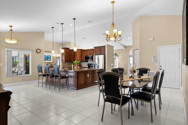a view of a dining room with furniture and chandelier