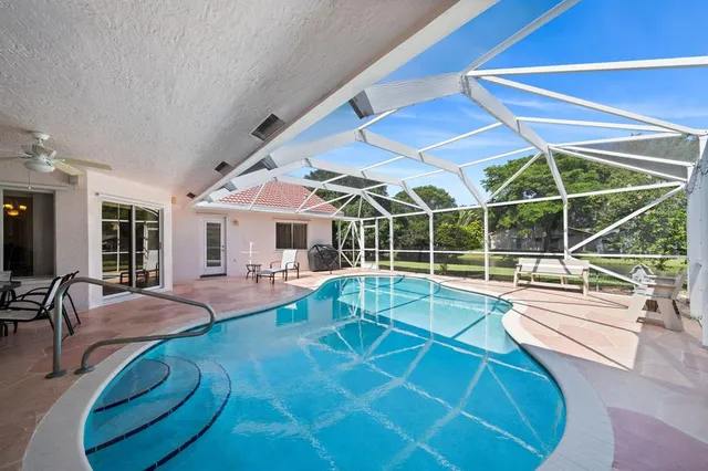 a view of a house with pool and sitting area