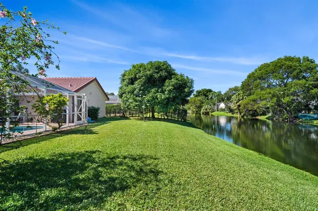 a view of pool with a yard