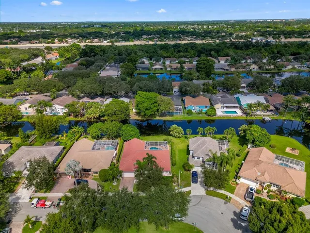 an aerial view of a houses with a lake