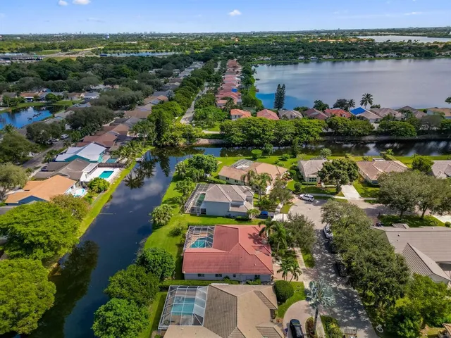 an aerial view of lake residential house with swimming pool and outdoor space