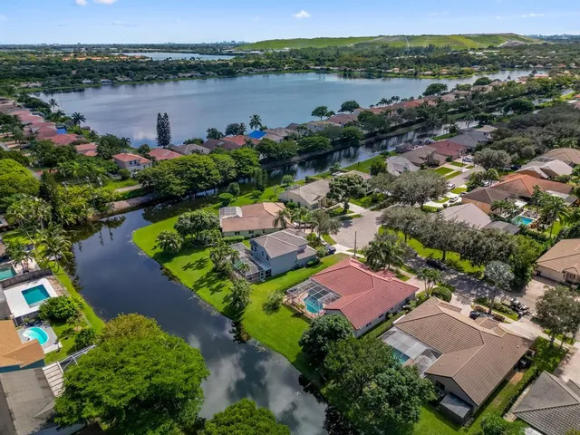 an aerial view of a house with outdoor space and lake view