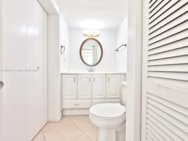 a bathroom with a toilet a sink and a mirror