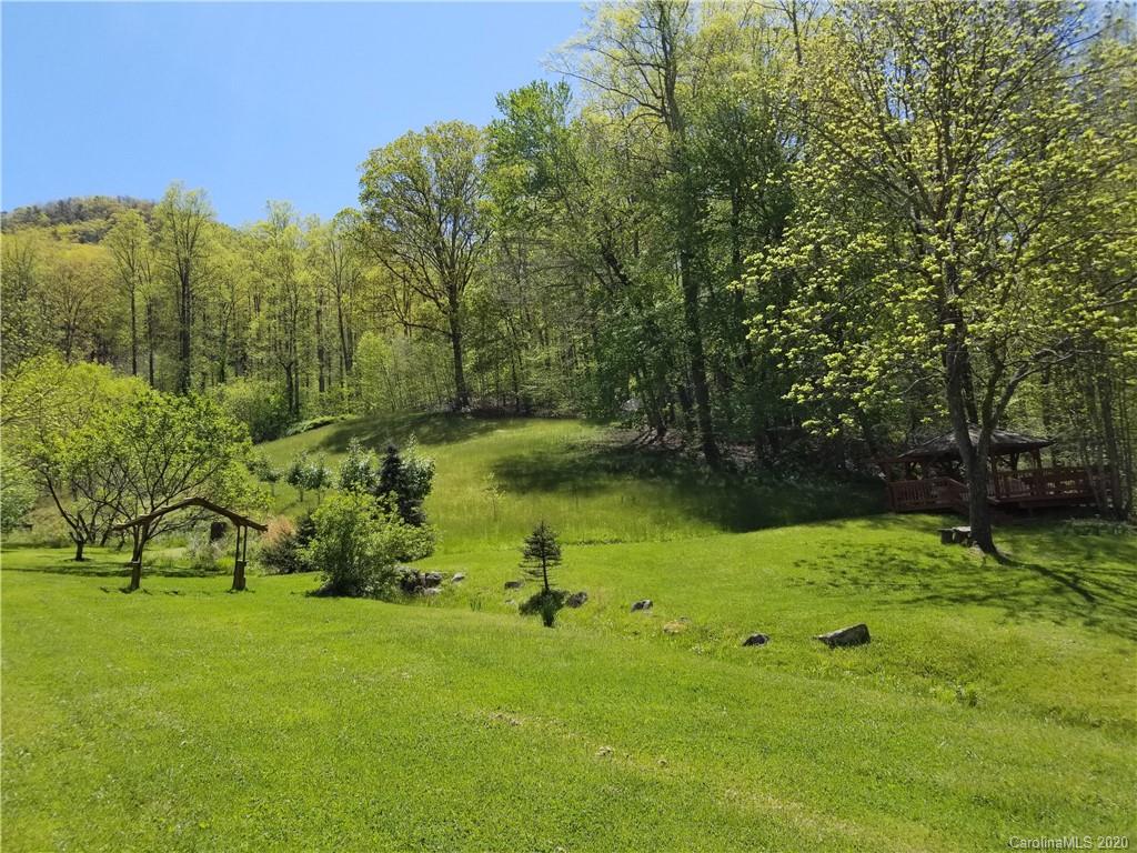 84 Brahma Ridge Candler, NC 28715 - Photo 22 of 30 a view of a garden with a bench