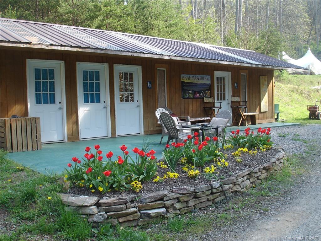 84 Brahma Ridge Candler, NC 28715 - Photo 23 of 30 a front view of a house with a porch and a garden