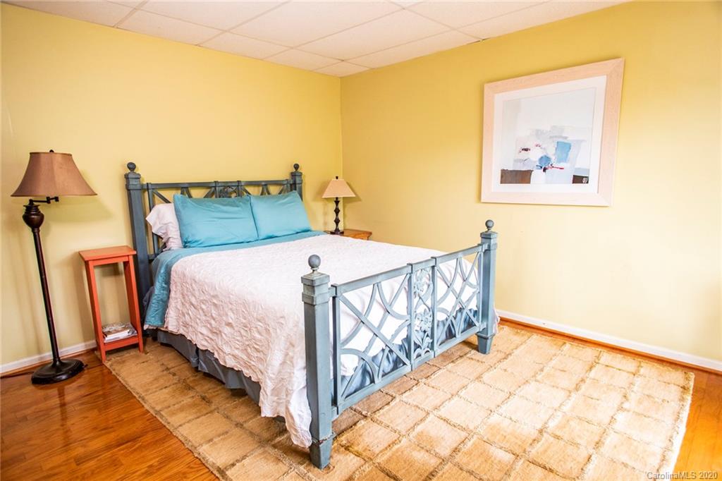 84 Brahma Ridge Candler, NC 28715 - Photo 8 of 30 a bedroom with a bed and wooden floor